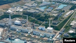 An aerial view shows the tsunami-crippled Fukushima Daiichi nuclear power plant and its contaminated water storage tanks (top) in this photo taken by Kyodo on August 31, 2013. (Reuters/Kyodo) 