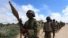 FILE - African Union Mission in Somalia (AMISOM) peacekeepers from Burundi patrol after fighting between insurgents and government soldiers on the outskirts of Mogadishu, May 22, 2012.