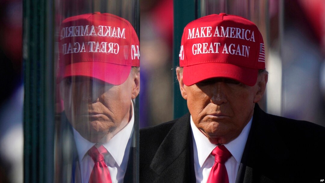 FILE - U.S. President-elect Donald Trump is reflected in bulletproof glass as he finishes speaking at a campaign rally in Lititz, Pennsylvania, Nov. 3, 2024. Trump's transition team said on Dec. 13, 2024, that "maximum pressure" is possible in regard to Iran's nuclear ambitions.