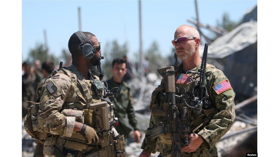 FILE - U.S. forces are seen at the Kurdish People's Protection Units (YPG) headquarters after it was hit by Turkish airstrikes in Mount Karachok near Malikiya, Syria, Apr. 25, 2017.