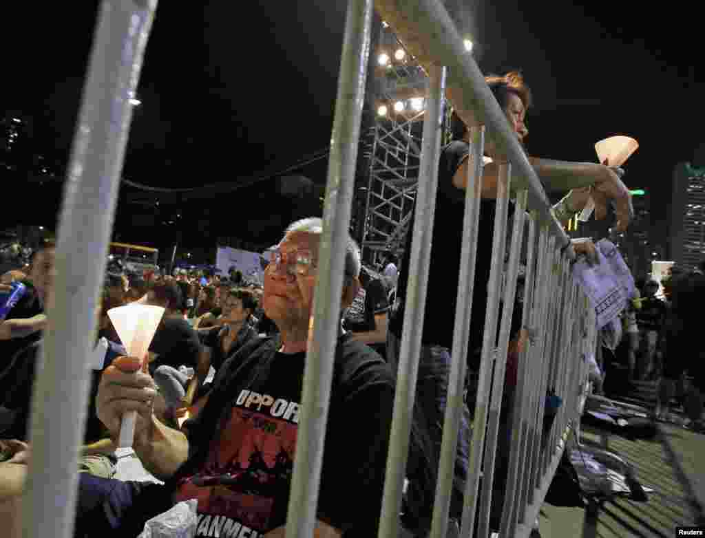 People take part in a candlelight vigil at Hong Kong's Victoria Park, June 4, 2012 to commemorate those who died during the military crackdown of the pro-democracy movement at Beijing's Tiananmen Square on June 4, 1989.