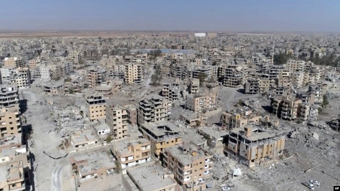 This Oct. 19, 2017, frame grab made from drone video shows damaged buildings in Raqqa, Syria.
