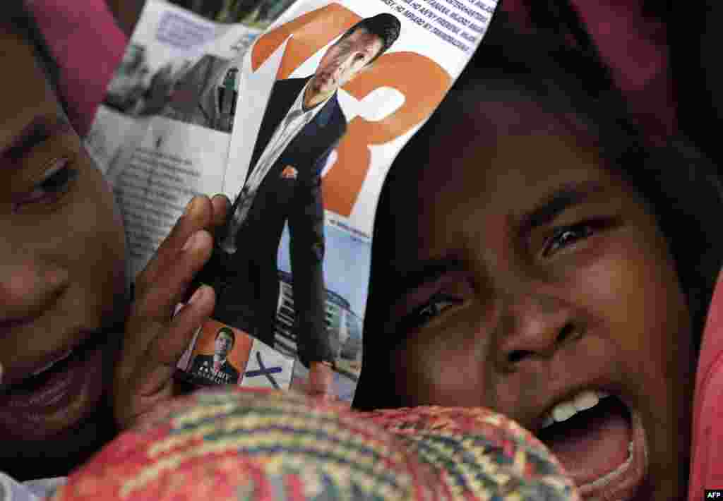 A young girl attends presidential candidate Andry Rajoelina's election rally in Antananarivo, Madagascar.