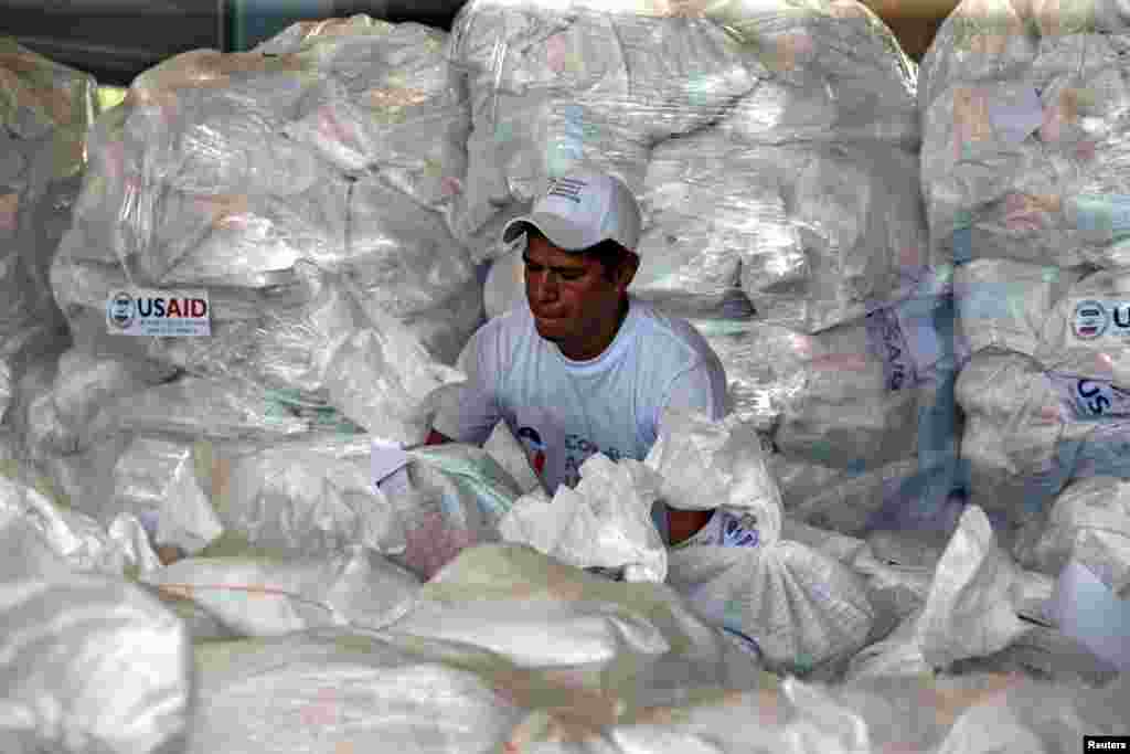 A worker organizes humanitarian aid for Venezuela at a warehouse near the Tienditas cross-border bridge between Colombia and Venezuela, in Cucuta, Colombia.