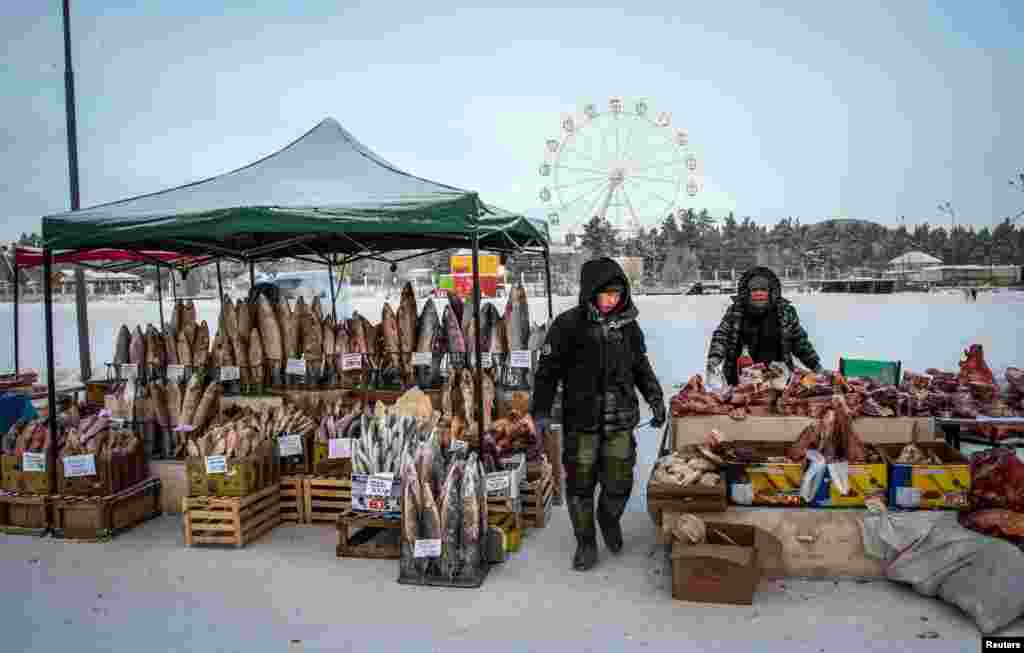 Vendors sell fish and meat products at a farmers' market in the eastern Siberian city of Yakutsk, Russia, Nov. 26, 2018.