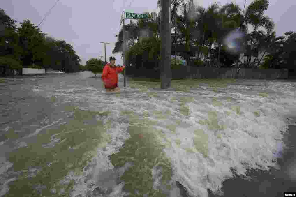 Amelia Rankin stands in flooded waters in Hermit Park, Townsville, Queensland, Australia.