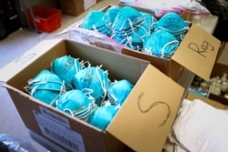 FILE - Boxes of N95 protective masks for use by medical field personnel are seen at a New York state emergency operations incident command center during the coronavirus outbreak in New Rochelle, N.Y., March 17, 2020.