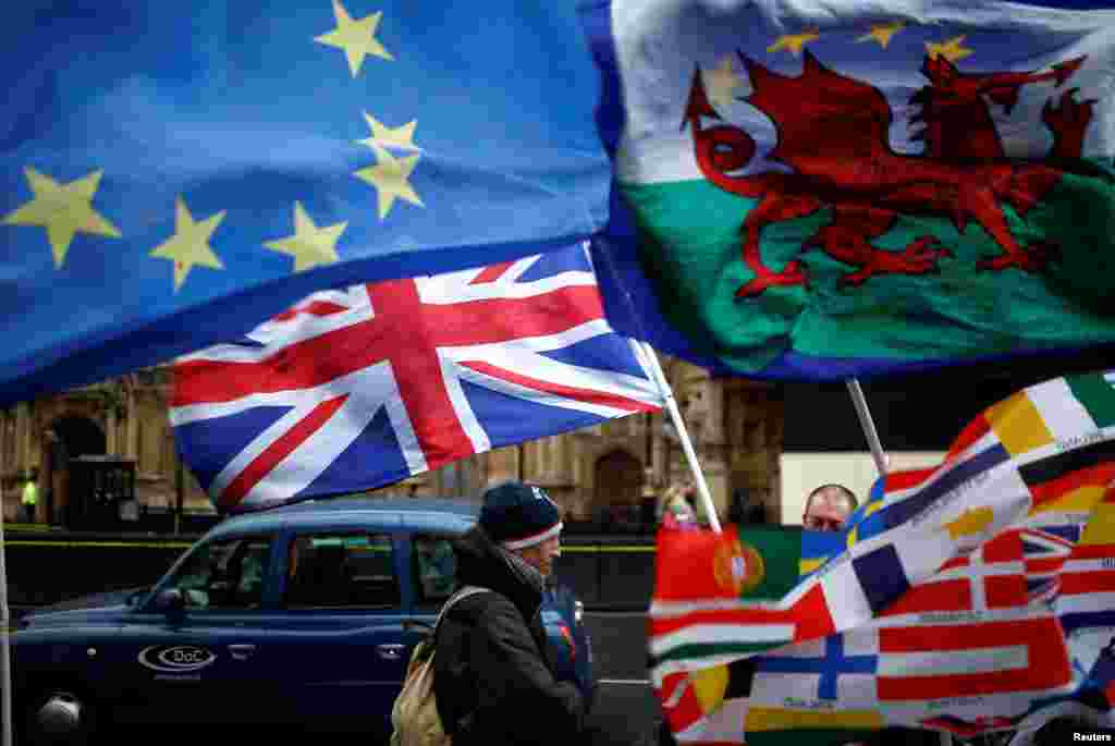 Flags flutter outside the Houses of Parliament, after Prime Minister Theresa May's Brexit deal was rejected, in London, Britain.