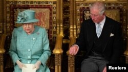 Britain's Queen Elizabeth II sits on the Sovereign's Throne next to Prince Charles during the State Opening of Parliament at the Palace of Westminster in London, Britain, Dec. 19, 2019.