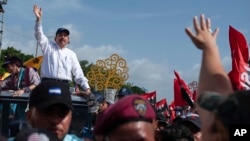 El presidente de Nicaragua, Daniel Ortega, y su esposa, la vicepresidenta Rosario Murillo, llegan a la plaza Juan Pablo II para celebrar el 39 aniversario de la revolución sandinista, en Managua, Nicaragua. (Foto AP/Cristóbal Venegas)
