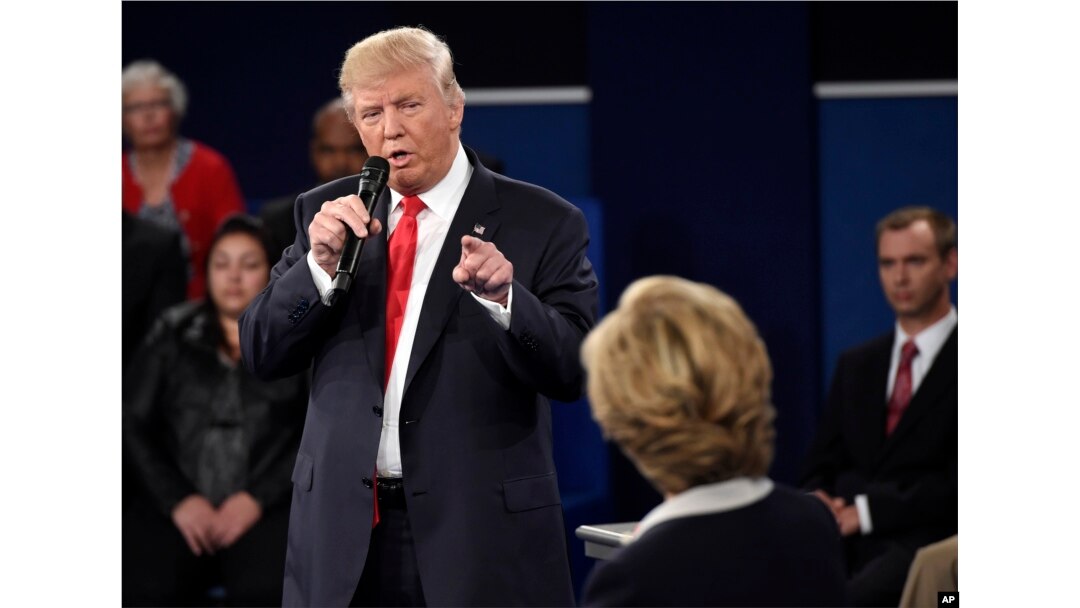 Republican presidential nominee Donald Trump points at Democratic presidential nominee Hillary Clinton as he speaks during the second presidential debate at Washington University in St. Louis, Oct. 9, 2016.