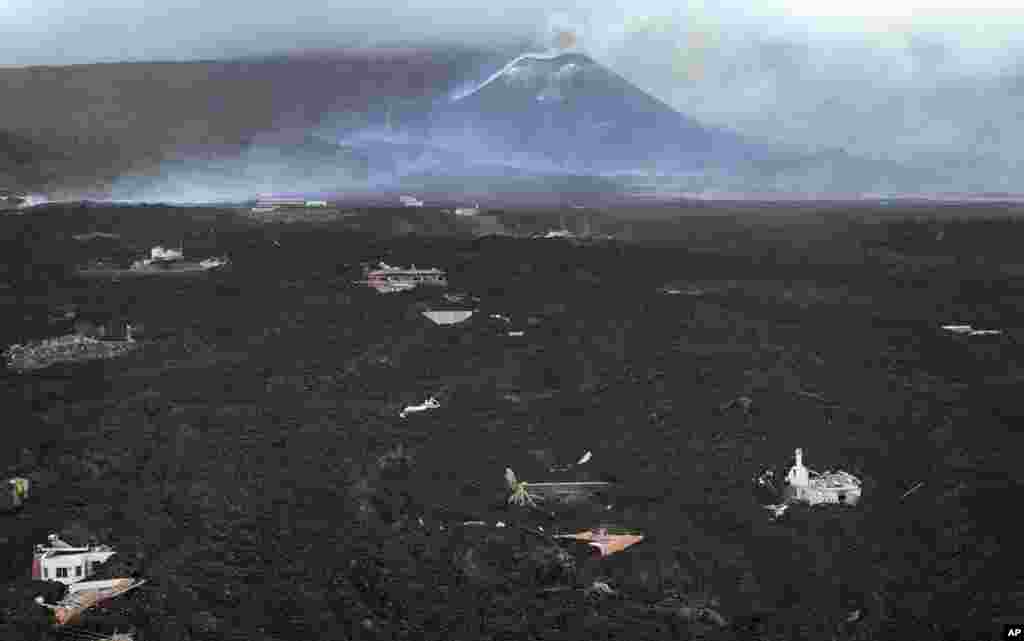 Lava flows destroying houses as volcano continues to erupt on the Canary island of La Palma, Spain.