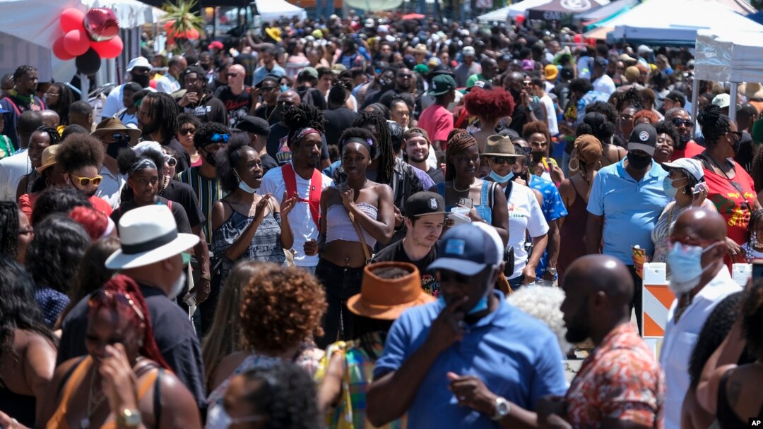 FILE - A crowd of people take part in a Juneteenth commemoration at Leimert Park Plaza in Los Angeles on June 19, 2021.