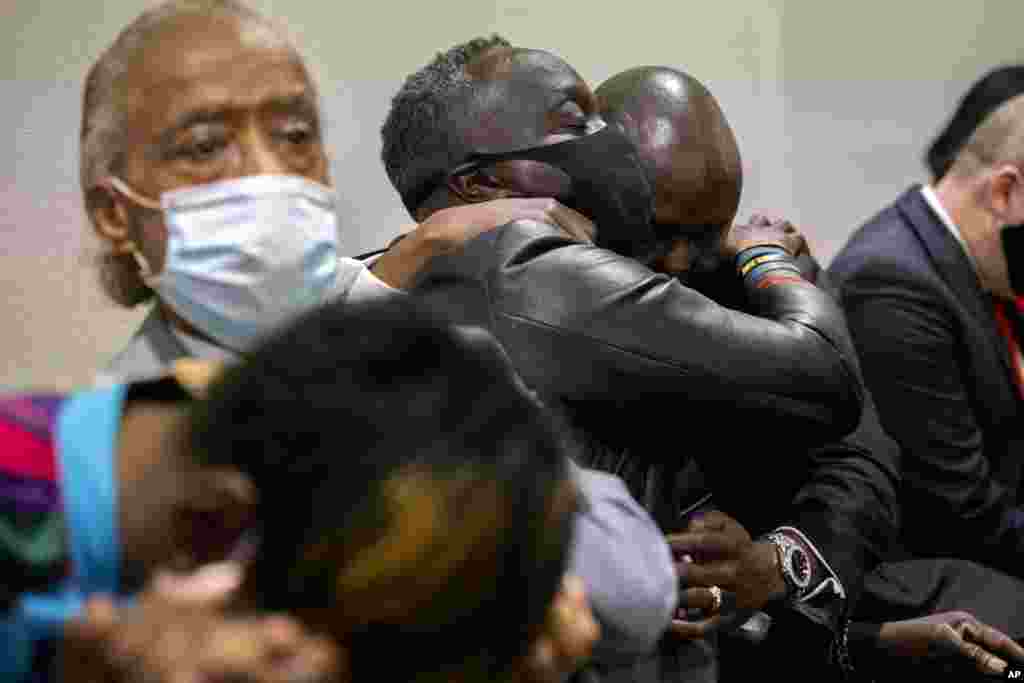 Ahmaud Arbery's father Marcus Arbery, center, his hugged by his attorney Benjamin Crump after the jury convicted Travis McMichael in the Glynn County Courthouse in Brunswick, Ga. Greg McMichael and his son, Travis McMichael, and a neighbor, William "Roddie" Bryan, charged in the death of Ahmaud Arbery were convicted of murder in the fatal shooting.