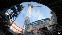 The Tokamak complex is pictured at the construction site of the ITER ( the International Thermonuclear Experimental Reactor), in the CEN of Cadarache, in Saint-Paul-Lez-Durance, southern France, Wednesday, Dec. 13, 2017. (AP Photo/Claude Paris)