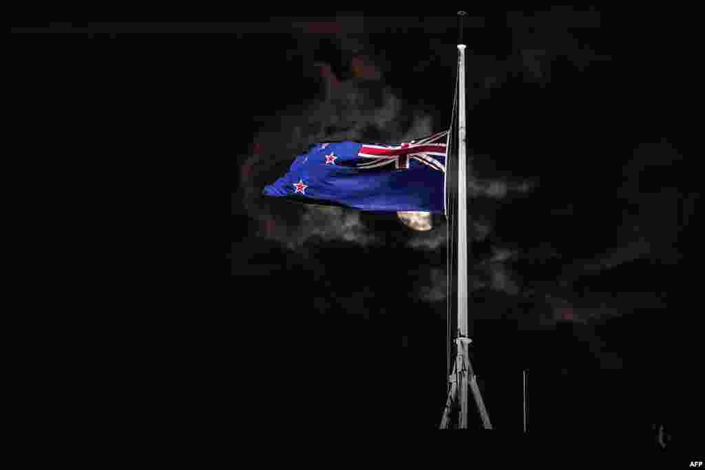 The New Zealand national flag is flown at half-mast on a Parliament building in Wellington after attacks on two Christchurch mosques left at least 49 dead on March 15, with one gunman identified as an Australian extremist, apparently livestreaming the assault that triggered the lockdown of the New Zealand city.