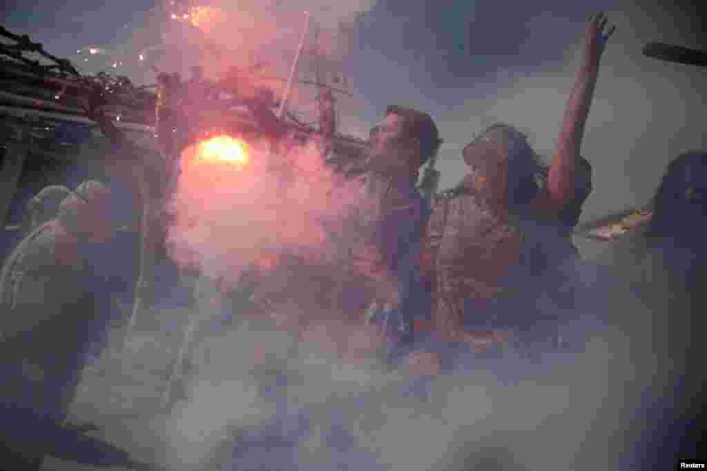 Revelers celebrate 'Ash Monday' by participating in a colorful 'flour war', a traditional festivity marking the end of the carnival season and the start of the 40-day Lent period until the Orthodox Easter, in the port town of Galaxidi, Greece.