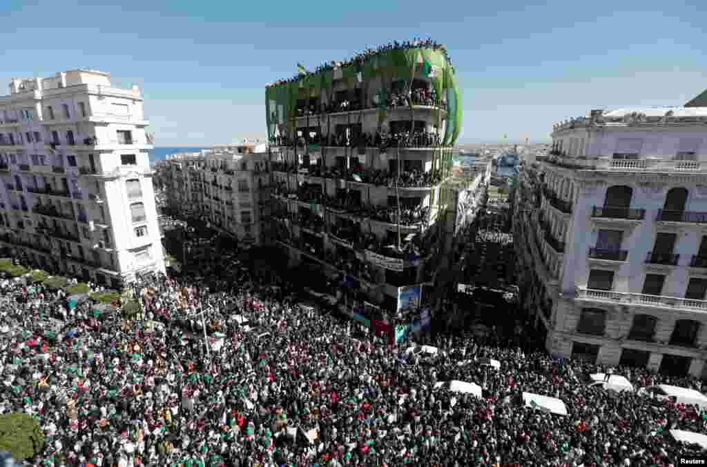 People gather during a protest over President Abdelaziz Bouteflika's decision to postpone elections and extend his fourth term in office, in Algiers, Algeria.
