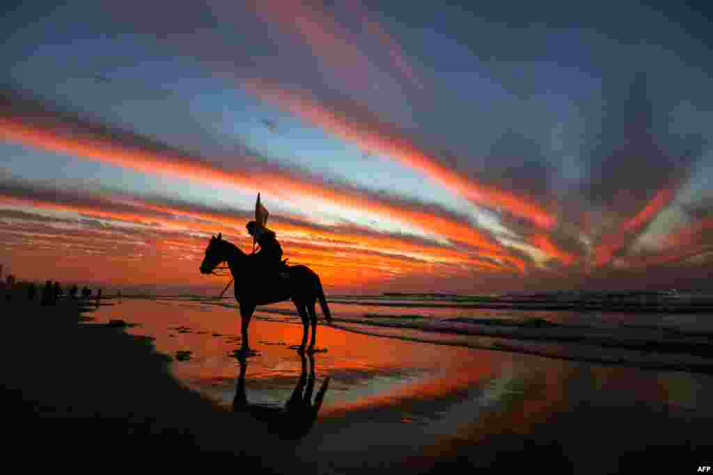 A Palestinian horseman rides on the beach at sunset a few hours prior to the New Year's celebrations, in Gaza city.