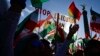FILE - Protesters hold up a placard reading "Stop Execution in Iran" as they take part in a rally in support of the demonstrations in Iran, in front of the Victory Column (Siegessaeule) in Berlin, Oct. 22, 2022. Three men were injured Oct. 30 when a pro-d