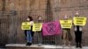 Activists from Extinction Rebellion use bike locks to chain themselves to a fence during a demonstration outside the G-20 summit in Rome, Italy, Oct. 31, 2021. 
