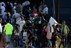 FILE - Refugees and migrants arrive at the port of Thessaloniki, northern Greece, Sept. 2, 2019.