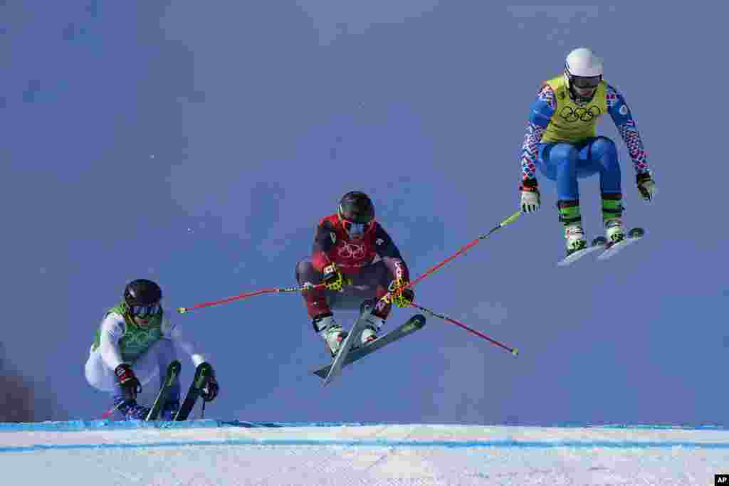 Sergey Ridzik of the Russian Olympic Committee leads the pack, followed by Canada's Brady Leman and Sweden's David Mobaerg, during the men's cross finals at the 2022 Winter Olympics, in Zhangjiakou, China.