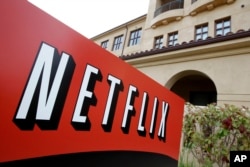 FILE - A sign points to Netfilx headquarters in Los Gatos, Calif.