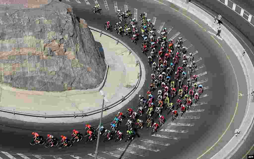 The pack rides during the second stage of the cycling Tour of Oman between Royal Cavalry Oman and al-Bustan.