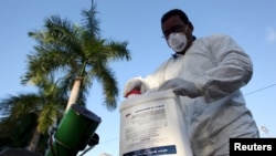 FILE - A health worker prepares insecticide before fumigating a neighborhood in San Juan, Puerto Rico, Jan. 27, 2016. On Friday, an elderly man on the U.S. territory became the first victim of the Zika virus on U.S. soil.