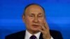 Russian President Vladimir Putin holds his annual end-of-year news conference in Moscow, Dec. 23, 2021.