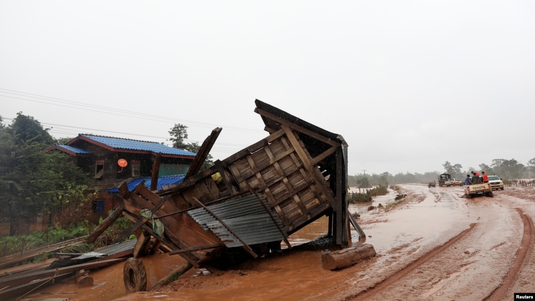 A military helicopter flies during the flood after the Xe Pian-Xe Namnoy hydropower dam collapsed in Attapeu province, Laos, July 26, 2018.
