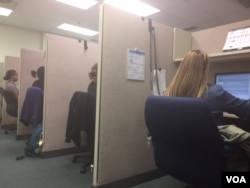 A bank of phone interviewers conducting surveys at SSRS. Valentina Martinez (in foreground) says her constant battle is to convince respondents that she's not a telemarketer. "We're not selling you anything." (C. Presutti/VOA)