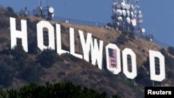 FILE - This 2001 photo shows the famed Hollywood sign in the Hollywood Hills with an American flag positioned over the letter O.