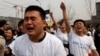 Family members of passengers of Malaysia Airlines flight MH370 cry as they shout slogans during a protest in front of the Malaysian embassy in Beijing March 25, 2014.