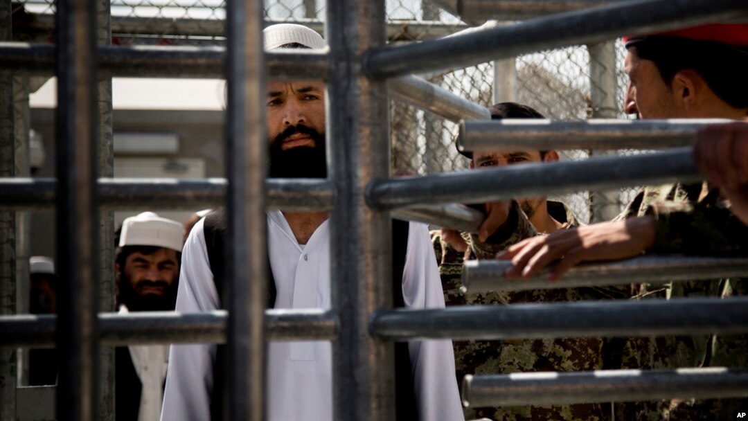 FILE - An Afghan prisoner waits in line for his release from Parwan Detention Facility after the U.S. military gave control of its last detention facility to Afghan authorities in Bagram, outside Kabul, Afghanistan, March 2013.