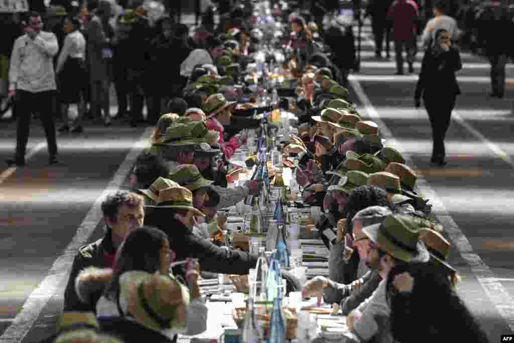 People take part in an attempt to break the Guinness World Records of the longest table to celebrate the international food market of Rungis' 50th anniversary, on March 17, 2019 in Rungis, outside Paris, France.