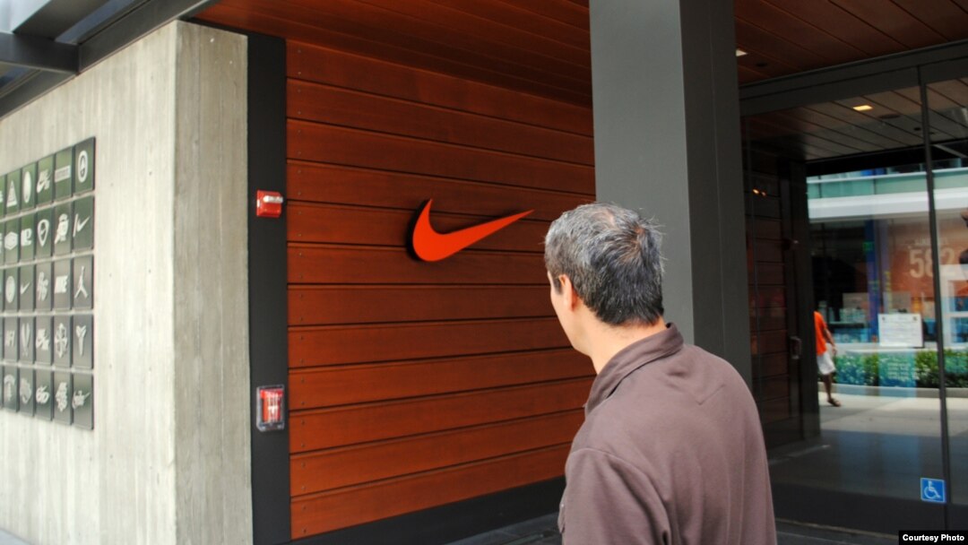 FILE - A man walks past a Nike store in Los Angeles, California. (Photo by Diaa Bekheet)