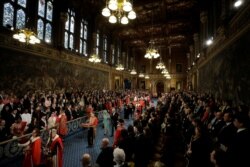 Britain's Queen Elizabeth and Britain's Prince Charles walk through the Royal Gallery before ahead of the Queen's Speech at the State Opening of Parliament ceremony at the Palace of Westminster in London, Britain, Dec. 19, 2019.
