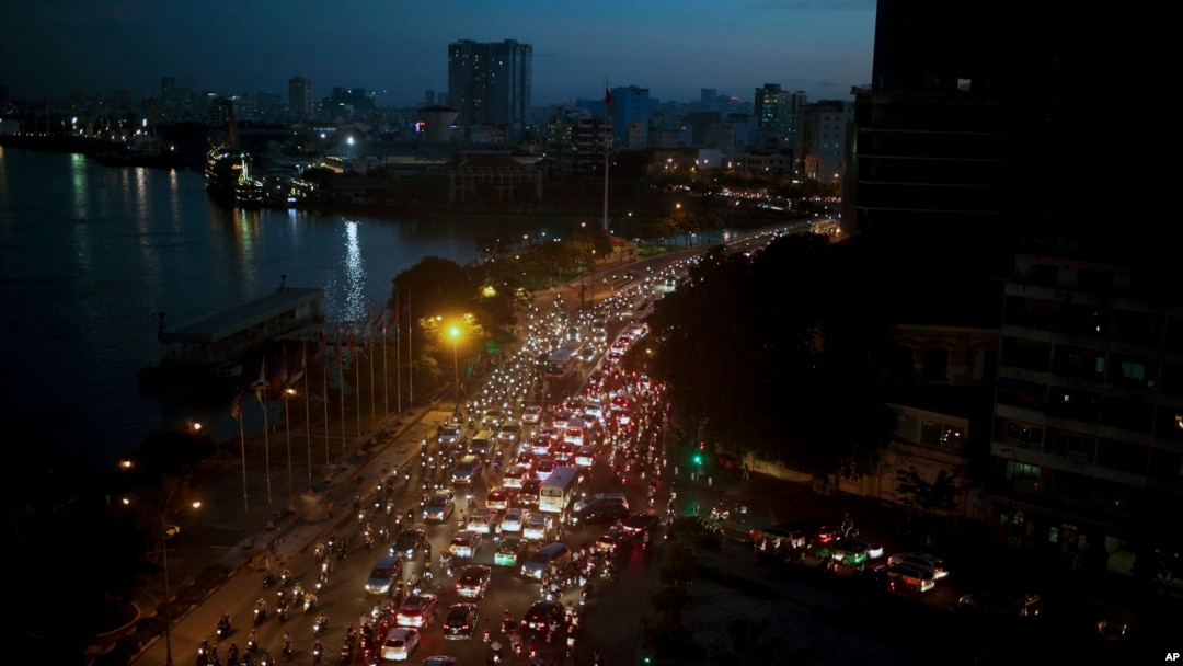 FILE - Traffic moves beside the Saigon River during rush hour in Ho Chi Minh City, Vietnam, Nov. 18, 2015. Senior officials warned at the time that air pollution levels in Ho Chi Minh City and Hanoi alone could soon match the deteriorating air quality of Beijing. A new report says Hanoi's air is now as dirty as Beijing's.