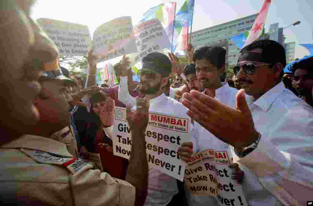 Police stop a group of the students from the National Students Union of India, during a protest outside the U.S. consulate in Mumbai. India's information minister lashed out at the United States on Friday and demanded an apology for the treatment and arrest of Devyani Khobragade, India's deputy consul general in New York.