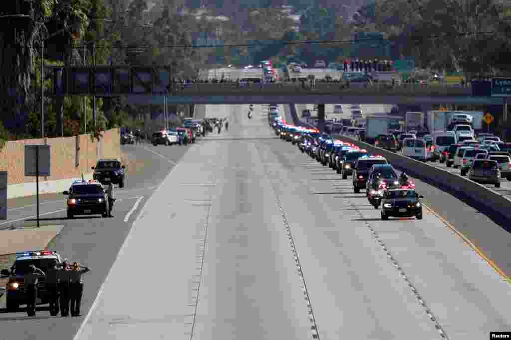 A procession for the body of Sergeant Ron Helus, who was shot in a shooting incident at a Thousand Oaks bar, drives down Ventura HIghway 101 in Thousand Oaks, California. Twelve were killed by a gunman late Wednesday during a shooting at the bar. Sheriff Sgt. Ron Helus was immediately hit with numerous gunshots after going inside to confront the shooter and later died after being taken to a hospital. 