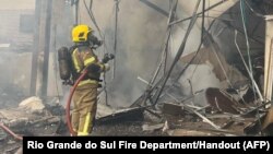 Handout picture released by Rio Grande do Sul Fire Department showing firefighters working on the site of a plane crash in Gramado, Rio Grande do Sul, Brazil, Dec. 22, 2024.