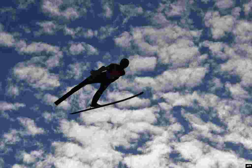 Ziga Jelar of Slovenia soars through the air during the men's HS130 ski jumping team event at the FIS Nordic World Ski Championships in Innsbruck, Austria.