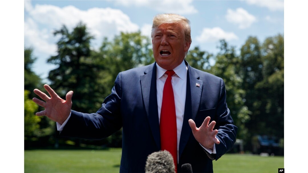 President Donald Trump talks with reporters on the South Lawn of the White House before departing to Japan for the G-20 summit, June 26, 2019.