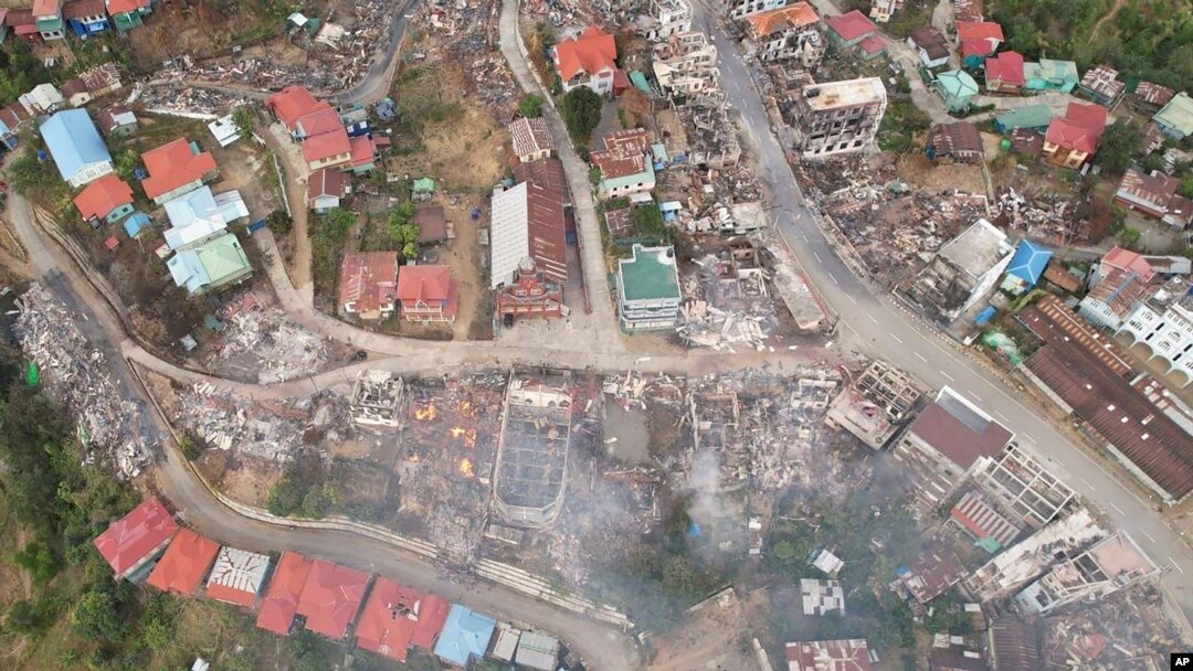 In this aerial photo released by the Chin Human Rights Organization, buildings are seen destroyed by fires in the town of Thantlang, in Chin State, in northwest Myanmar, Dec. 4, 2021. 