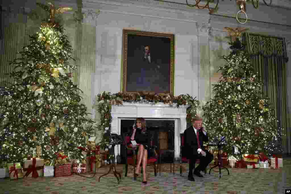 President Donald Trump and first lady Melania Trump speak on the phone at the White House, sharing updates to track Santa's movements from the North American Aerospace Defense Command (NORAD) Santa Tracker on Christmas Eve, Dec. 24, 2018.