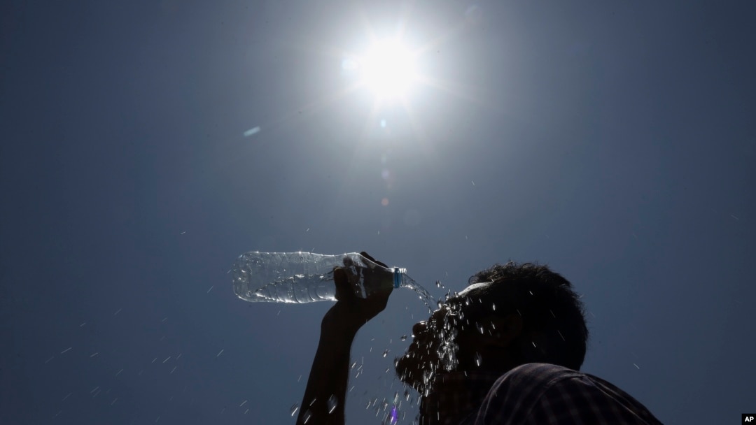 FILE - An Indian man pours water on his face during a hot summer day in Hyderabad, India, May 24, 2015. 