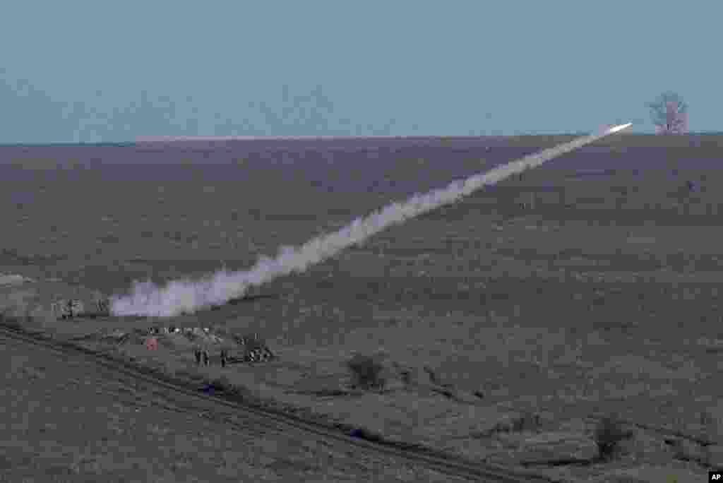 Ukrainian soldiers launch an anti-aircraft rocket during military exercises near Urzuf, south coast of Azov sea, eastern Ukraine.