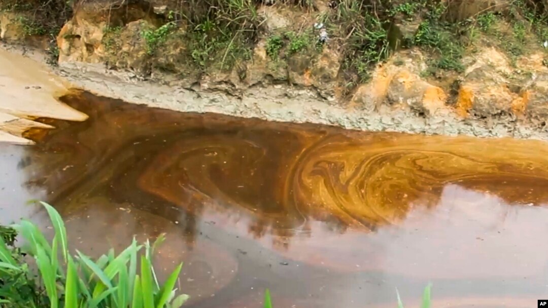 FILE - Oil from a spill pollutes the Okuku River in Ogoniland, Nigeria, on Sept. 16, 2023. Amnesty International on July 5, 2024, raised a red flag about two companies the Nigerian government has hired to assess a proposed sale of Shell's onshore assets.